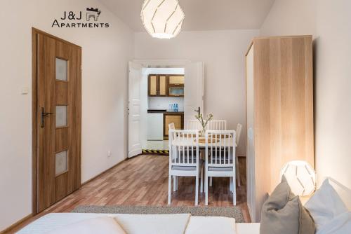 a living room with a table and a dining room at J&J Apartments, Szeroka 25 Apartament 7 in Toruń