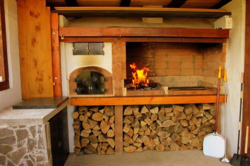 a fireplace with a pile of fire wood at Kuća za odmor Gorski Kotar in Brestova Draga