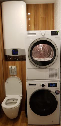 a washing machine and a toilet in a bathroom at Luxury Apartments In Top City Center Varna 2 in Varna City