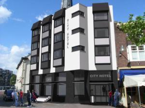 a large building with people standing outside of it at City Hotel Tilburg in Tilburg