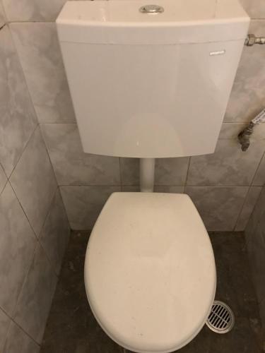 a white toilet in a bathroom with a sink at Taygetos in Sparti