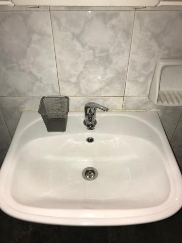 a white sink with a faucet in a bathroom at Taygetos in Sparti