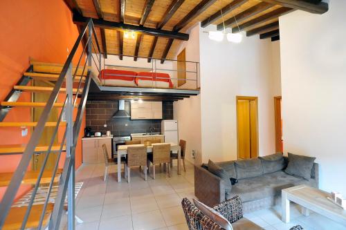 a living room with a staircase leading to a kitchen at Pyramid City Apartments in Agios Spyridon Corfu