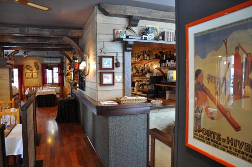 Apartamentos Los Pirineos - Atencion personal في بييسكاس: بار في مطعم مع صورة على الحائط