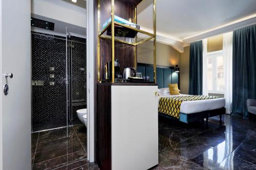 a bathroom with a shower and a bed in a room at BQ House Colosseo Luxury Rooms in Rome