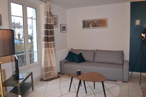 a living room with a couch and a table at Meudon : idéal pour séjour à Paris in Meudon