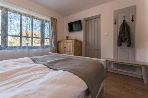 a bedroom with a large bed and a window at Villa Lenka in Tiszafüred