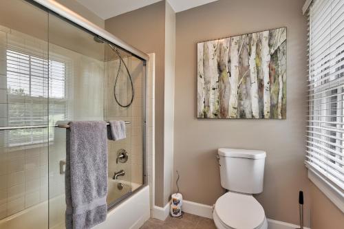 a bathroom with a toilet and a glass shower at Pleasanton Courtyard Bed and Breakfast in Fayetteville