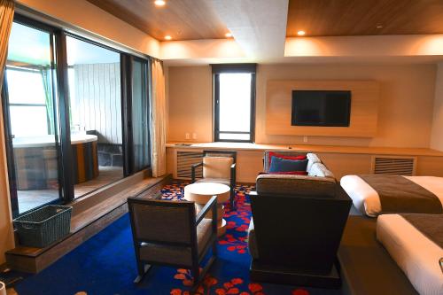 a hotel room with a bed and a tv at Karuizawakurabu Hotel 1130 Hewitt Resort in Tsumagoi