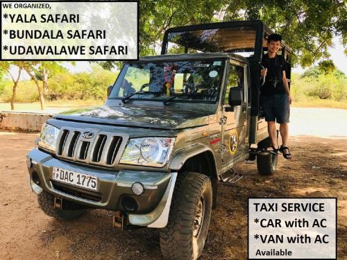 a man standing next to a jeep with its doors open at Castle Resort Yala in Tissamaharama