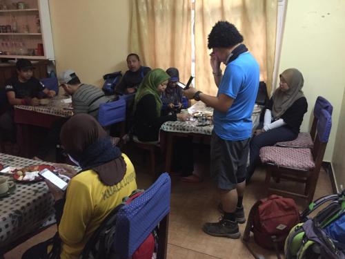 a group of people sitting at tables in a room at New United Hotel in Pokhara