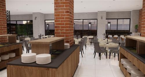 a restaurant with tables and chairs and a brick wall at Phoenix Hotel Karon Beach in Karon Beach