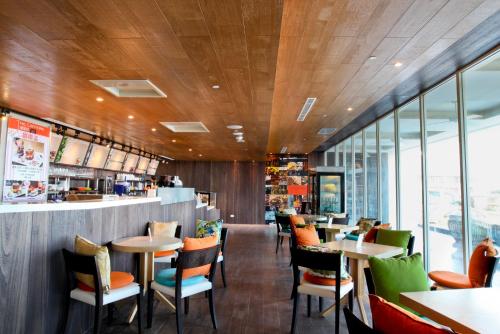 a restaurant with wooden ceilings and tables and chairs at Inhouse Hotel Yehliu in Wanli District