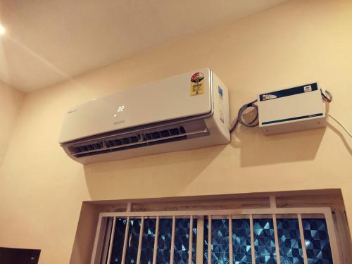 a air conditioner on a wall next to a window at Hotel Wins in Kanyakumari