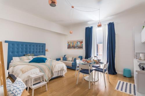 a bedroom with a blue bed and a table at Monolocale Casa Pepe Sorrento in Sorrento