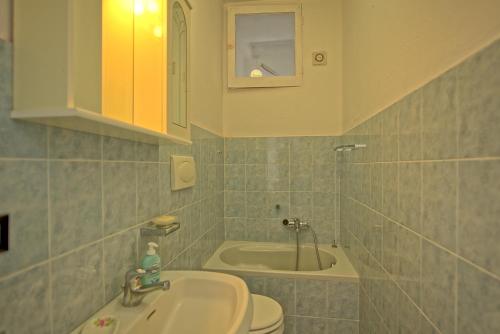 a bathroom with a sink and a toilet at Casa al Bosco by PosarelliVillas in Ameglia