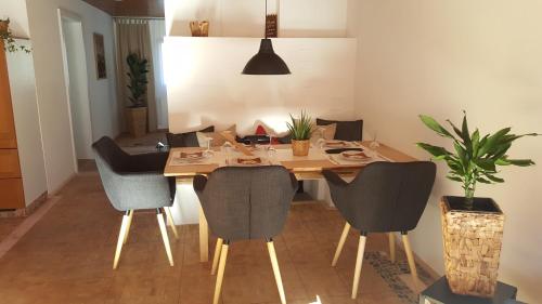 a dining room with a wooden table and chairs at Appartement Unterbergblick in Kössen