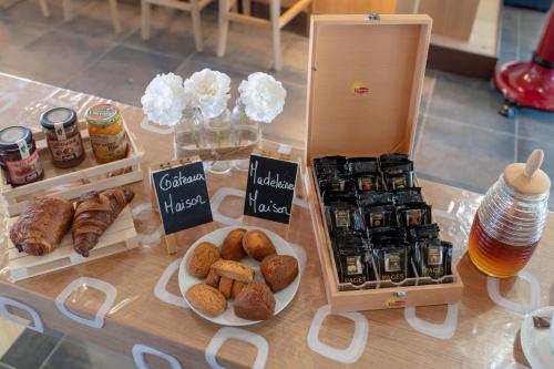 a table with different types of pastries and other foods at Résidence & Hotel U Livanti ECOLABEL in Propriano