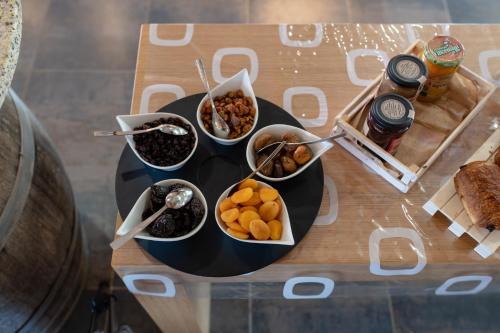 a table with bowls of food on a table at Résidence & Hotel U Livanti ECOLABEL in Propriano