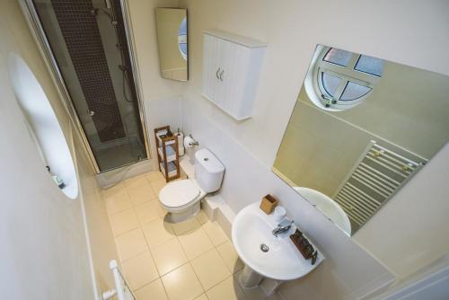 
a bathroom with a toilet and a sink at Jade - Royal Swan Quarter in Leatherhead
