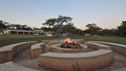 a fire pit in the middle of a field at African Rest Lodge in Barberton