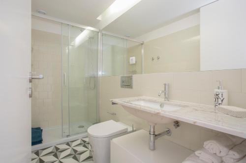 a bathroom with a sink and a toilet and a shower at Liiiving in Porto | Historic & Sunny Terrace in Porto