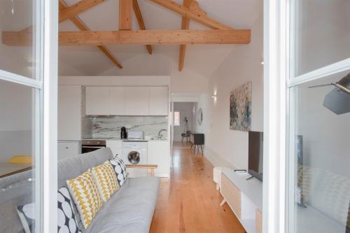 a living room with a couch and a kitchen at Liiiving in Porto | Historic & Sunny Terrace in Porto