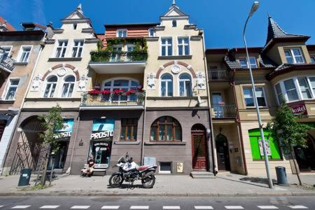 a motorcycle parked in front of a building at YOURAPART Sopot Centrum Plaza in Sopot