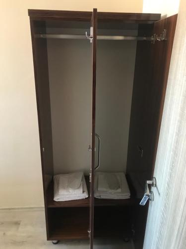 a brown cabinet with two beds in it at Gunes Hotel in Hacıbektaş