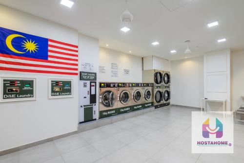 an empty laundry room with an american flag on the wall at HostaHome Suites at I-City, Central Mall in Shah Alam