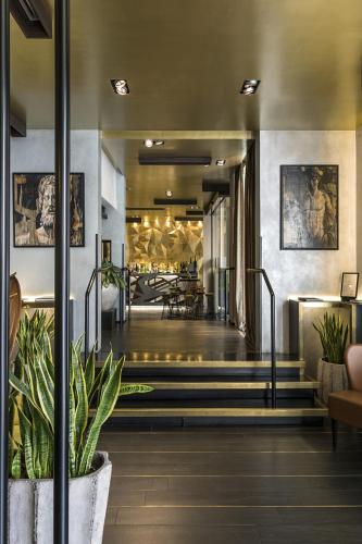 a lobby of a building with stairs and plants at Palazzo Navona Hotel in Rome