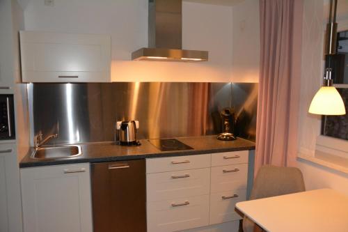 een keuken met een wastafel en een aanrecht bij BergZeit Apartment in Berchtesgaden
