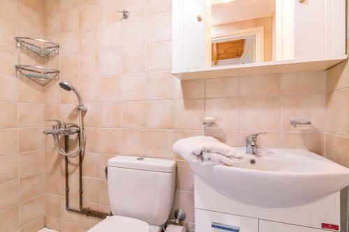 a bathroom with a toilet and a sink at Traditional Rustic Maisonette by Konnect in Agios Ioannis Peristeron