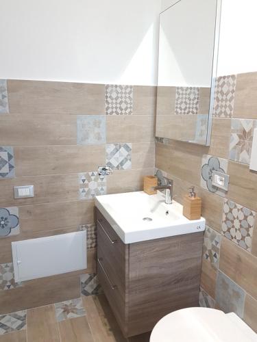 a bathroom with a sink and a toilet and a mirror at Al Bosco Ficuzza in Ficuzza