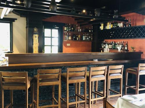 a bar with wooden stools in a restaurant at Dhulikhel Mountain Resort in Dhulikhel