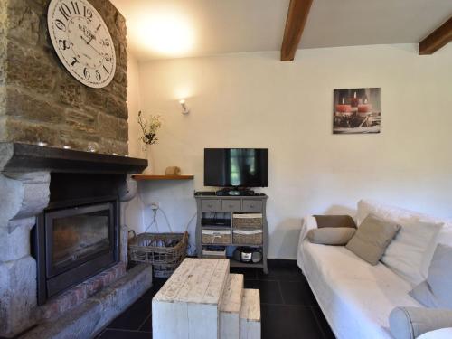 a living room with a couch and a fireplace at Charming gite in Les Avins situated by a stream in Modave