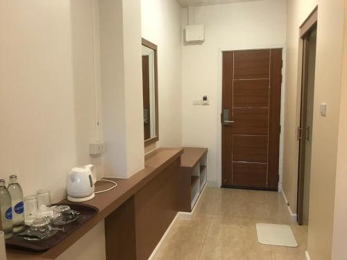 a bathroom with a counter with a sink and a mirror at The Sept Korat in Nakhon Ratchasima