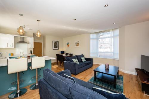 
a living room filled with furniture and a couch at Abbey Apartments in Barrow in Furness
