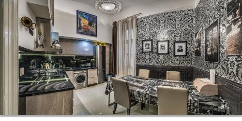 a kitchen with a table and a sink and a washing machine at Boudoir Budapest Apartment in Budapest