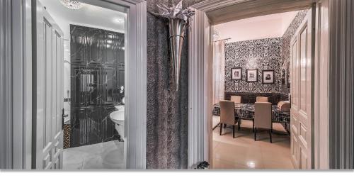 a dining room with a table and a dining room at Boudoir Budapest Apartment in Budapest