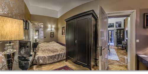 a bedroom with a bed and a black closet at Boudoir Budapest Apartment in Budapest