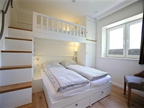 a bedroom with a bunk bed and a window at Blanker Hans Wohnung 4 in Wangerooge