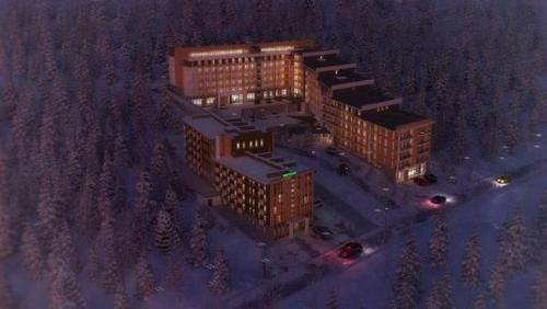an overhead view of a building with lights on at A Modern Suite Close to Gondola Ski Lift in Bakuriani