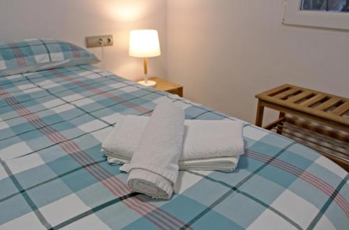 A bed or beds in a room at Apartamento 90 Toscamar