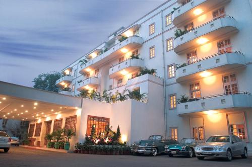 a large white building with cars parked in front of it at Ambassador, New Delhi - IHCL SeleQtions in New Delhi