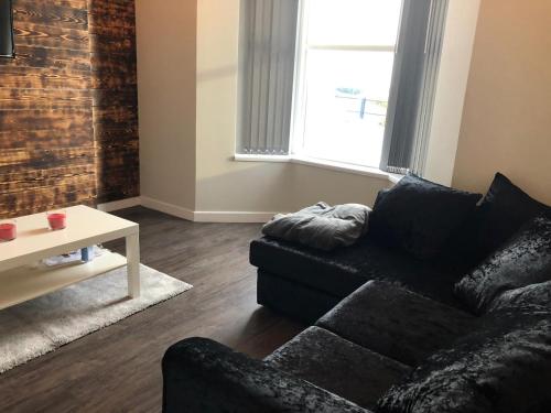 a living room with a couch and a table at 59 Wern Fawr Road in Swansea