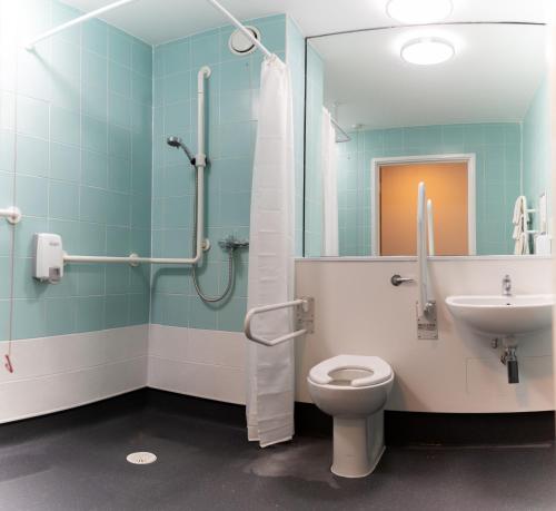 a bathroom with a toilet and a sink at The Olympic Lodge in Aylesbury