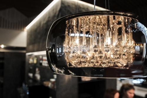 a bunch of wine glasses hanging from a chandelier at Hotel Ylläsrinne in Ylläsjärvi