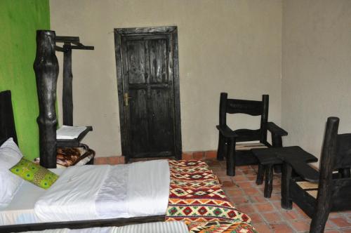 Postel nebo postele na pokoji v ubytování Nyungwe Nziza Ecolodge