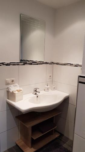 a bathroom with a white sink and a mirror at Am alten Skihang in Wallgau
